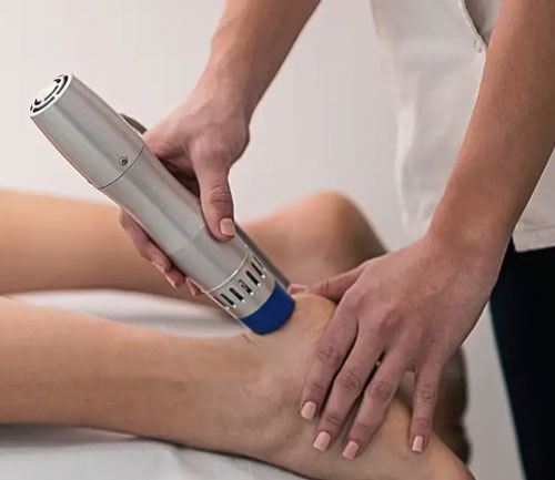 Shockwave therapy treatment on patient's knee